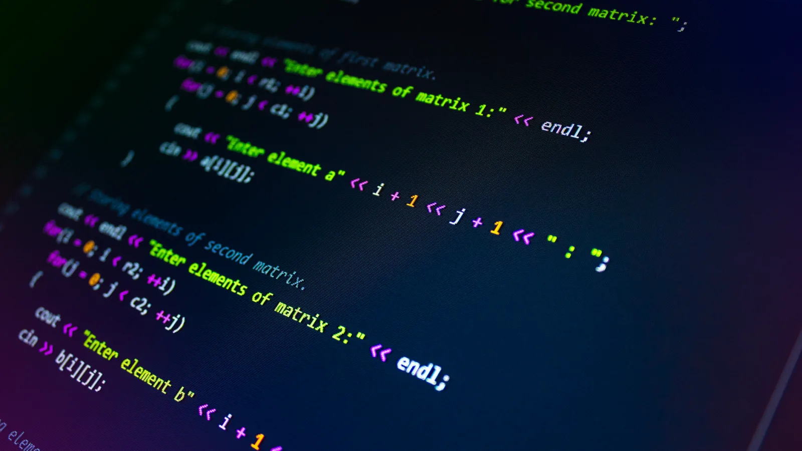 Developer looking at multiple code editors on a single monitor